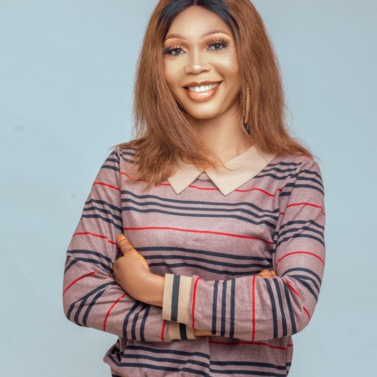 Avery Kim, Lead Design Curator at Adaptive Operations Network, reviewing corporate floral arrangements